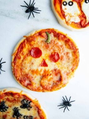 Jack o lantern Halloween pizza on the counter.