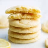 Stacked lemon sugar cookies on counter.