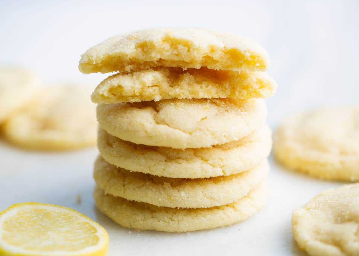 Stacked lemon sugar cookies on counter.