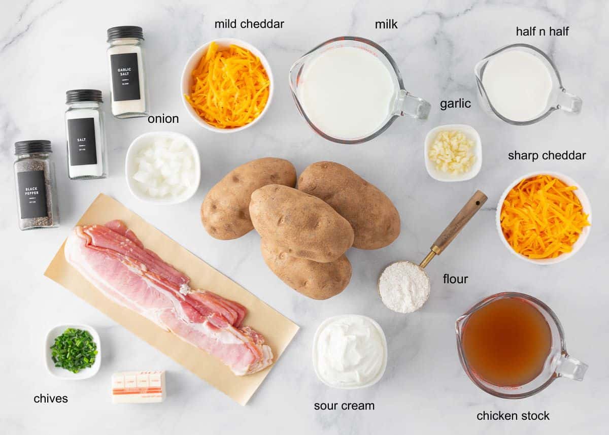 This loaded baked potato soup is the best comfort food! Made with tender potatoes, cheese, bacon and sour cream, it is a creamy and cozy soup recipe to enjoy all fall! Ingredients for loaded baked potato soup including Russet potatoes, bacon, cheddar cheese, milk, half-and-half, sour cream, chicken stock, onion, garlic, flour and chives.