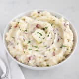 Mashed red potatoes in a bowl.