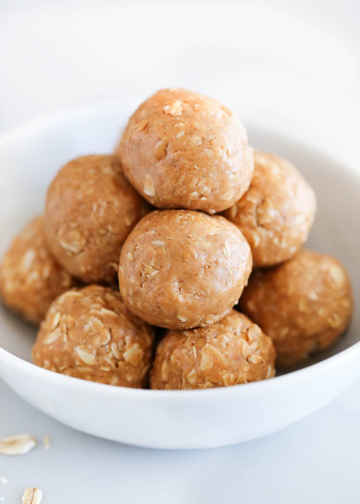 Peanut butter oatmeal balls in a white bowl. 