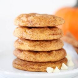 Stacked pumpkin snickerdoodles on a plate.