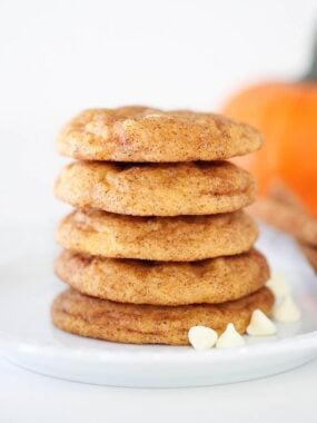 Stacked pumpkin snickerdoodles on a plate.