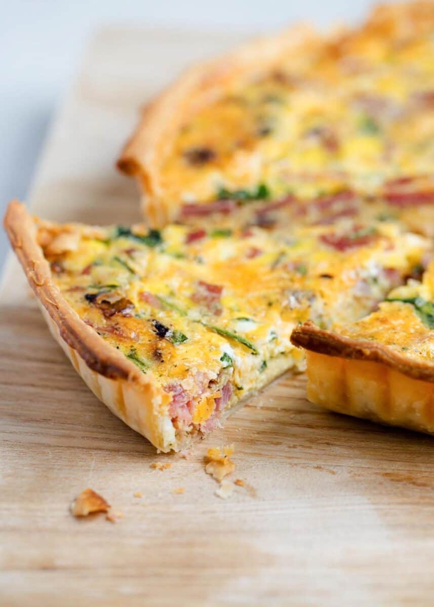 Slice of easy quiche recipe on board.