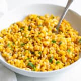 Skillet corn in white bowl.