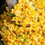 Cooking corn in an iron skillet.