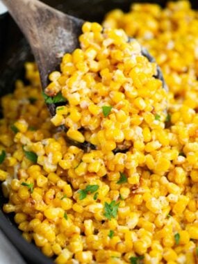 Honey butter skillet corn in a cast iron dish.