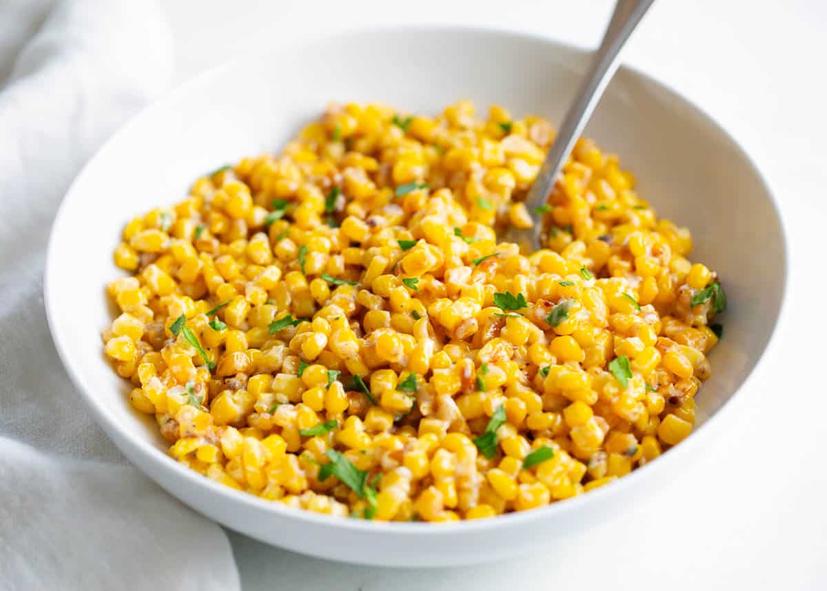 Skillet corn in white bowl. 