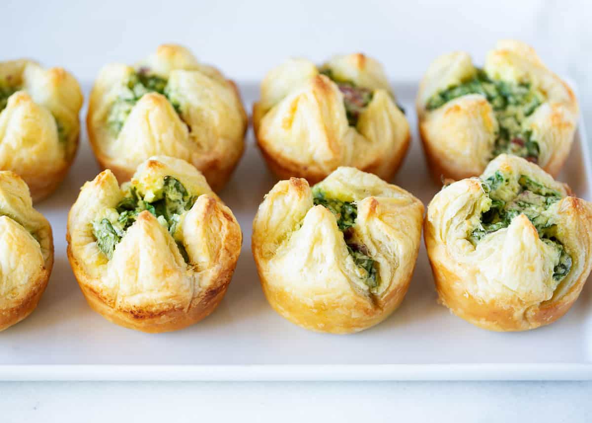 Spinach puffs on a white plate.