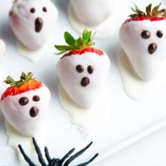 White chocolate strawberry ghosts on a plate.