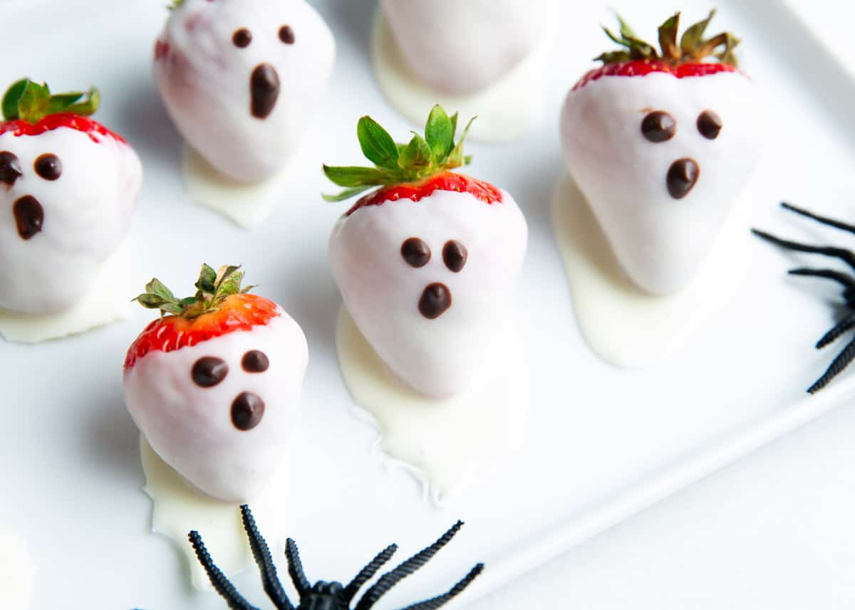 Chocolate strawberry ghosts on a plate. 