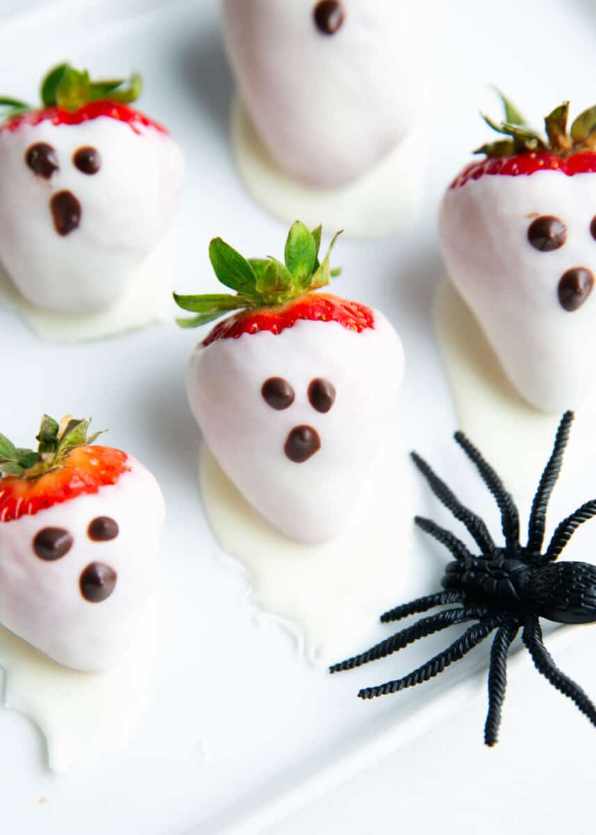 Chocolate covered strawberry ghosts on a plate.