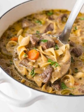 The best beef noodle soup in a white pot.