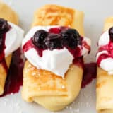 Cheese blintzes with blueberries on top.