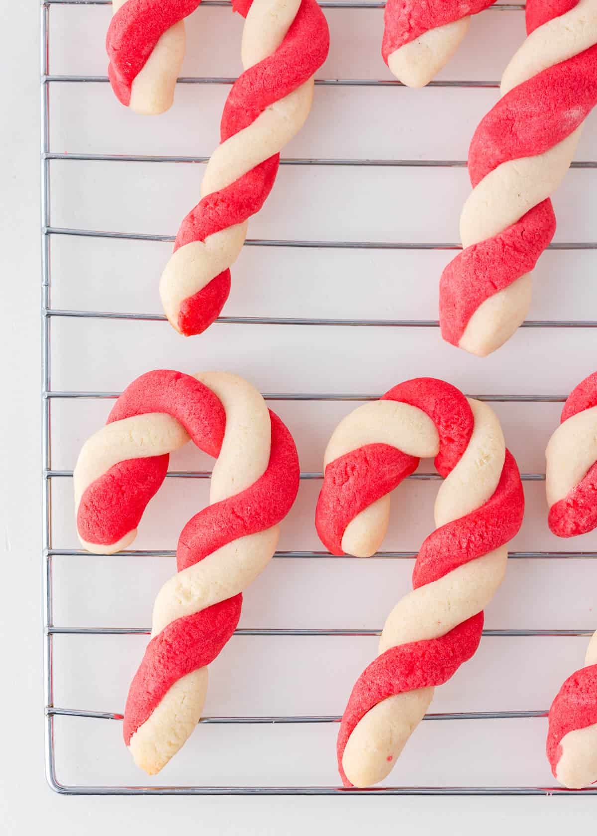 Candy cane cookies on a cooling rack.