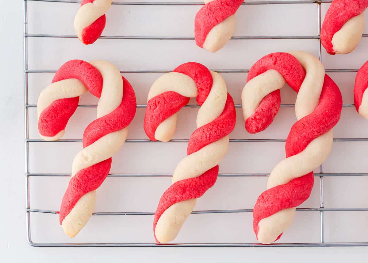 Candy cane cookies on a rack.