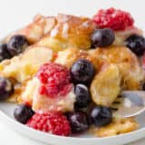 Croissant breakfast casserole with berries on a plate.