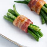 Green bean bundles on baking sheet.