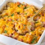 The best ham and potato casserole in a white baking dish.