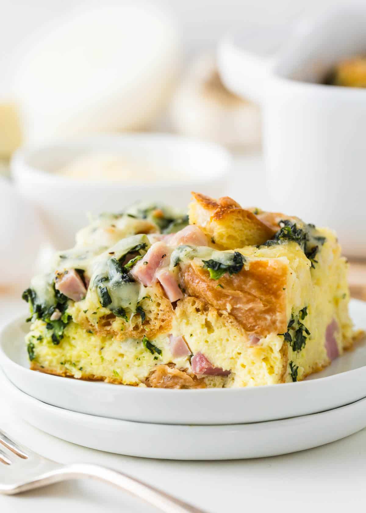 Breakfast strata on a white plate.