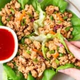 Thai chicken lettuce wraps with sauce on the side.