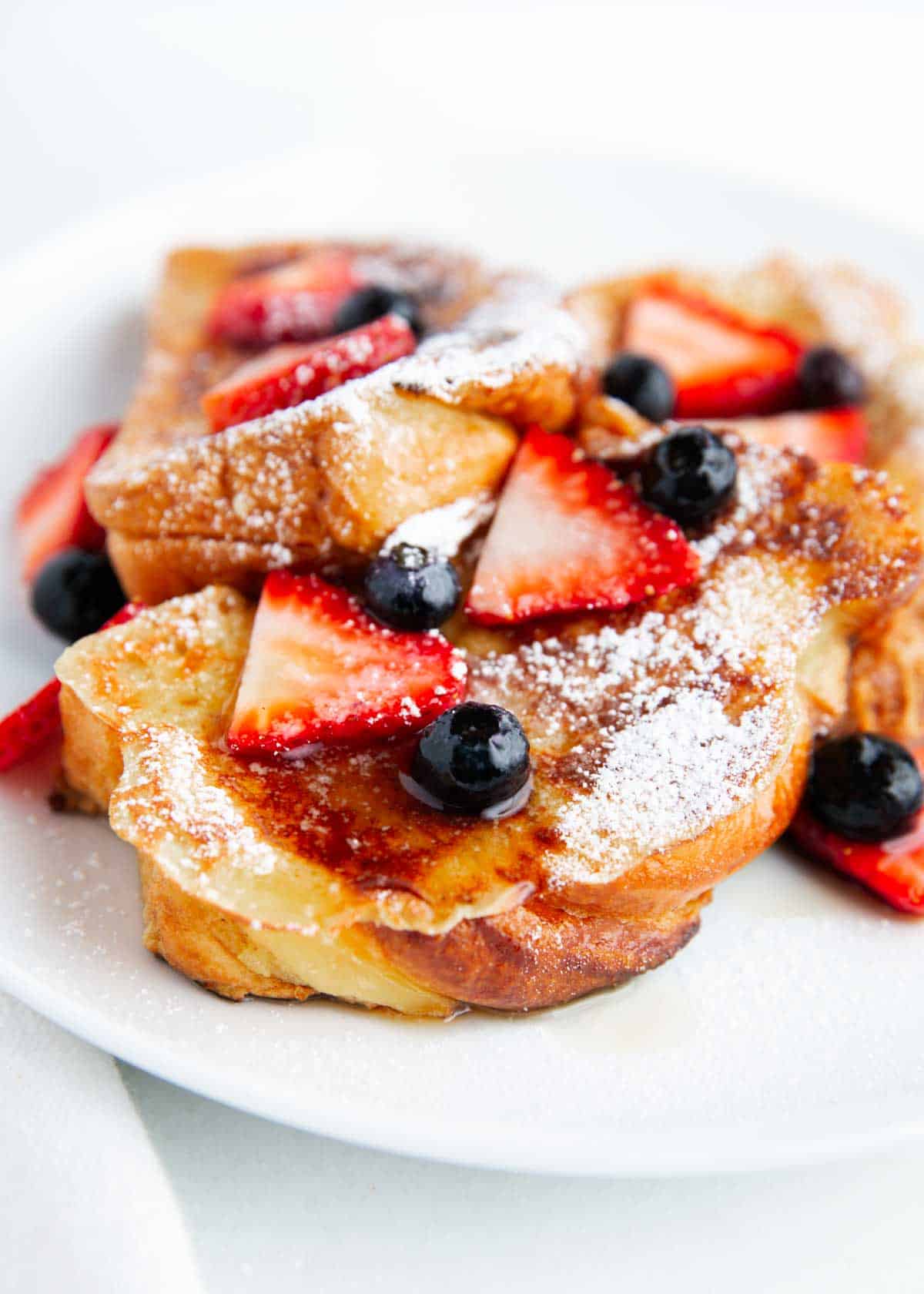 Sliced brioche french toast with berries.