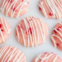 Cherry almond cookies made with a cream cheese dough, maraschino cherries and drizzled with white chocolate.
