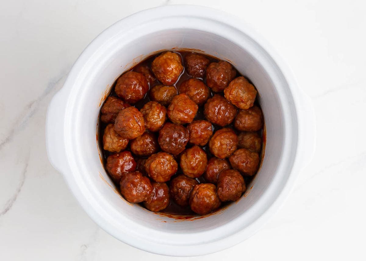 Showing how to make cranberry meatballs.