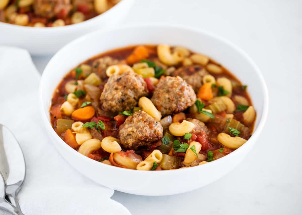 Meatball soup in a white bowl.