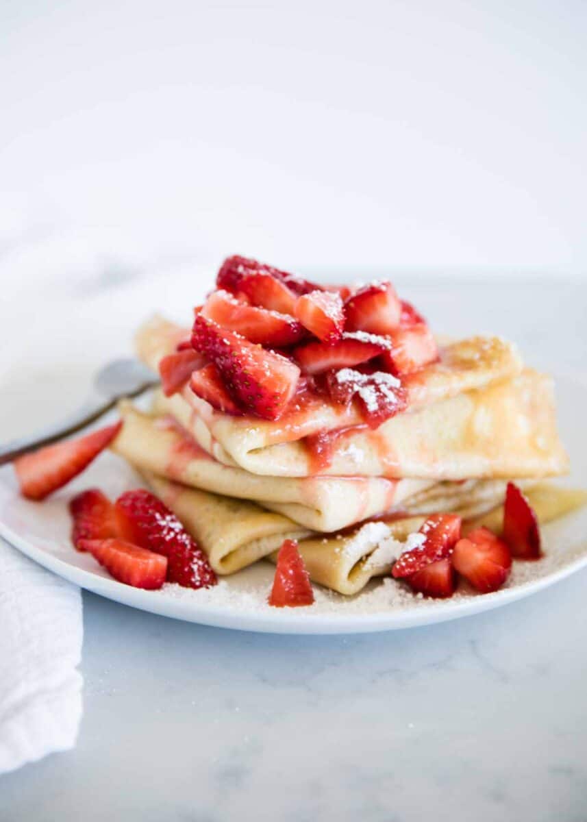 Strawberry crepes on a plate.