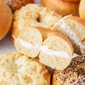 Stack of bagels with cream cheese.