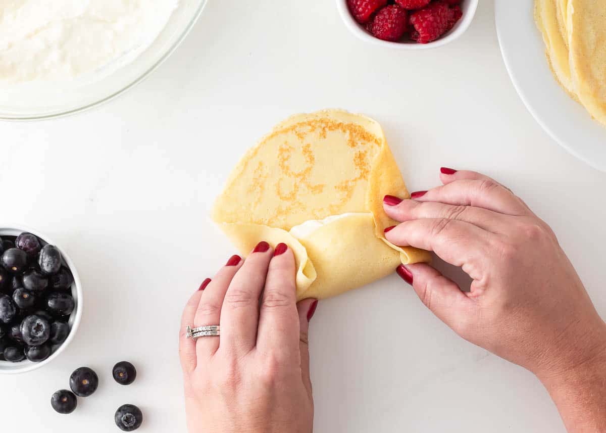 Blintz being rolled with filling.