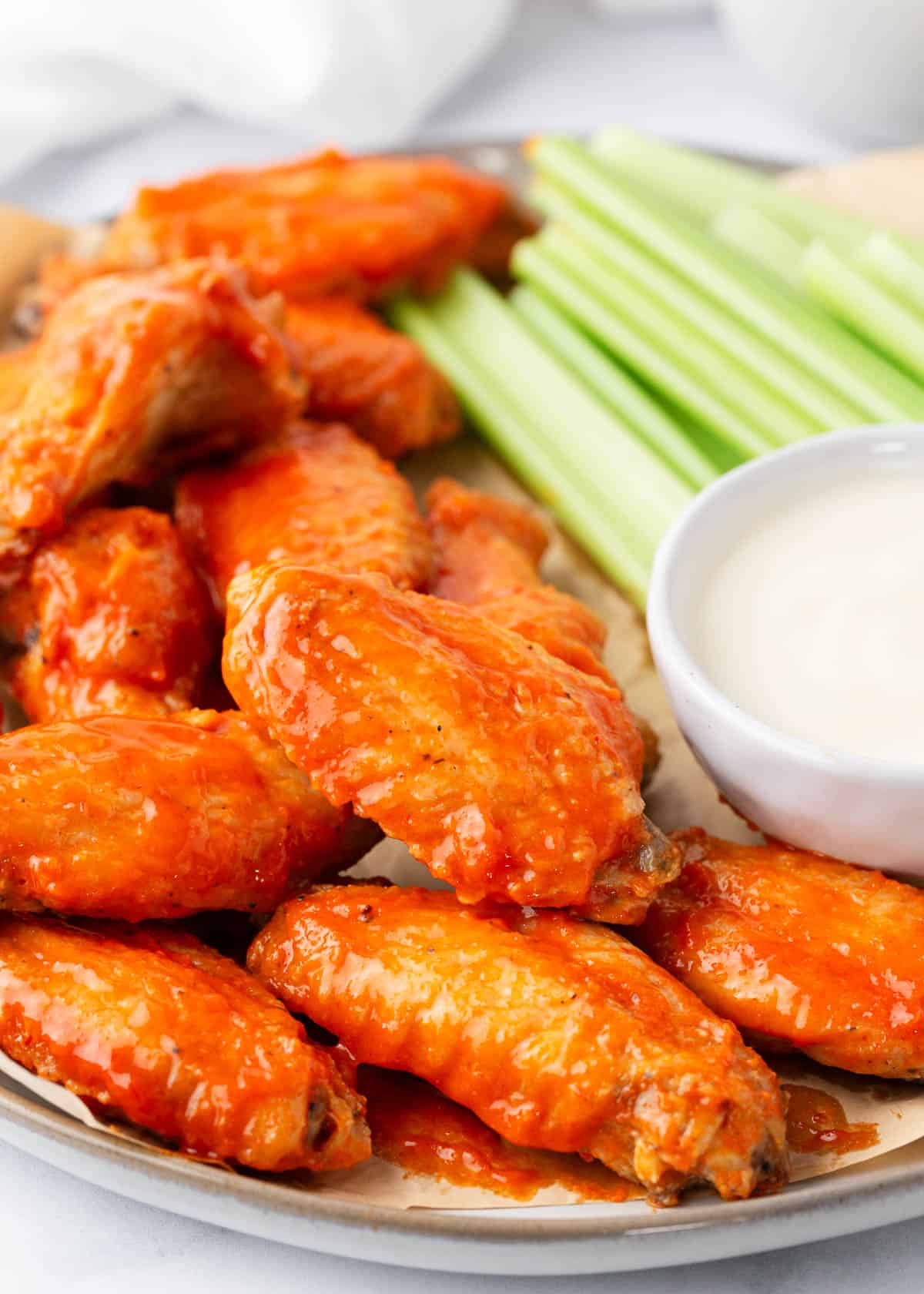 Buffalo wings on a plate with dip.