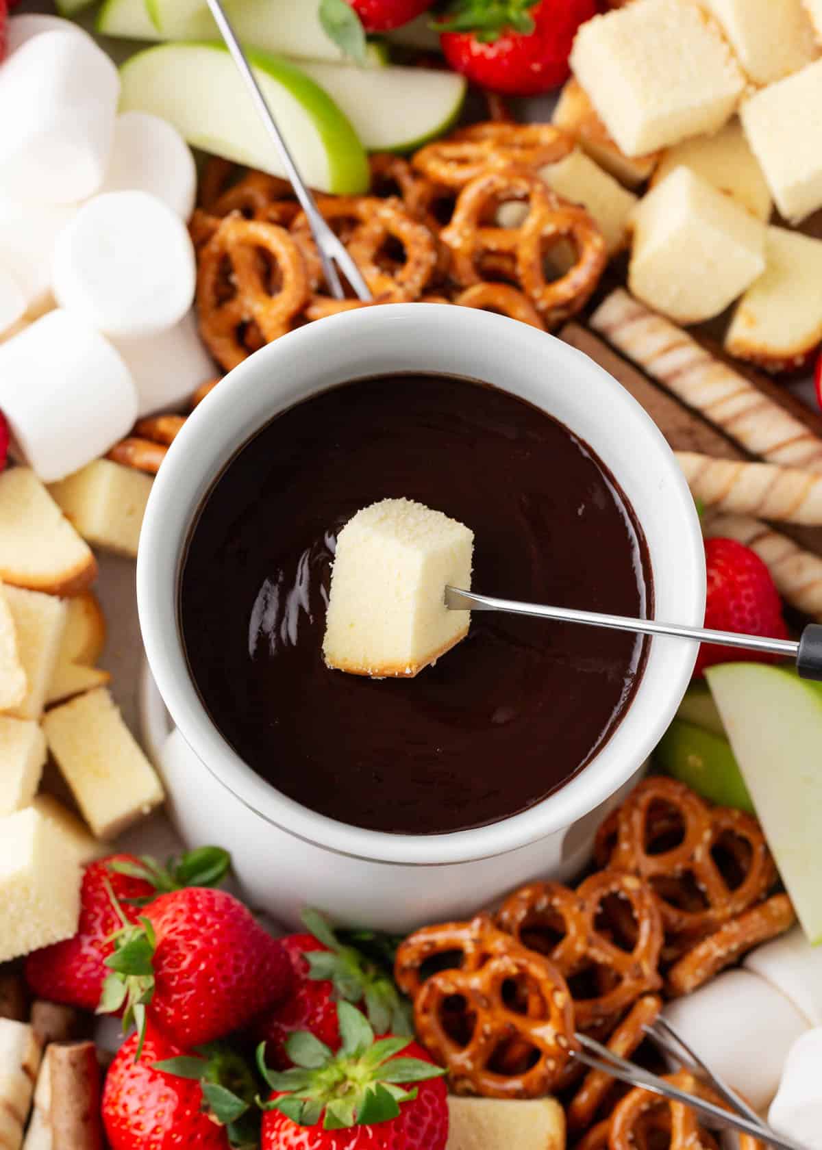 Dipping cake into chocolate fondue.