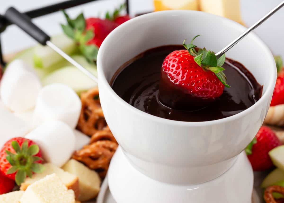 Dipping strawberry into chocolate fondue.