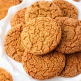 Gingersnap cookies on a white cake stand.