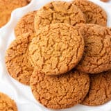 Gingersnap cookies on a white cake stand.