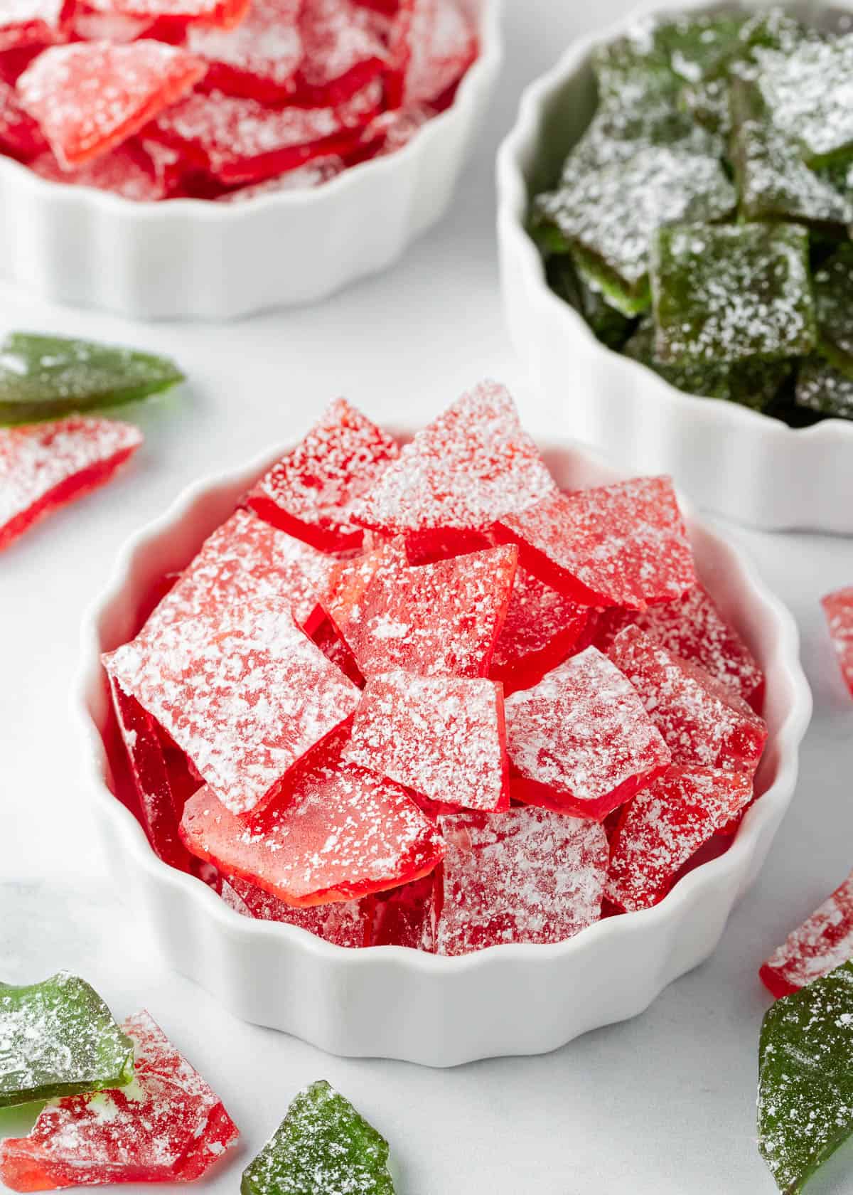 It's simple to make homemade hard candy with this easy to follow recipe that allows you to customize both the flavor and color. This old fashioned candy will be a new holiday favorite! Hard candy recipe for Christmas in bowls.