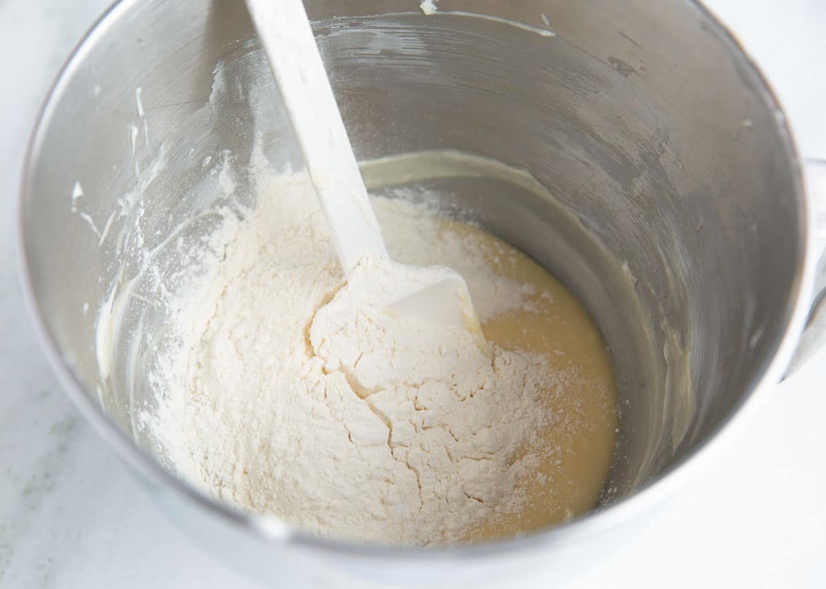 Making cream cheese cookie dough in a bowl.