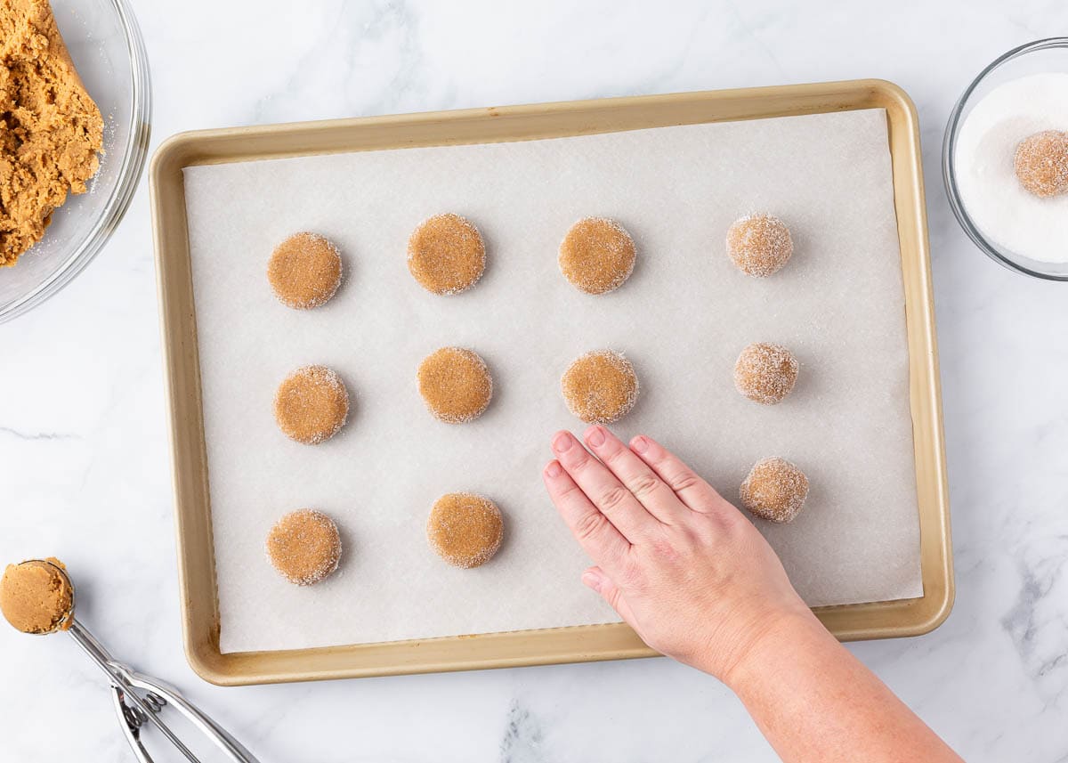 Rolling gingersnap cookie dough balls.