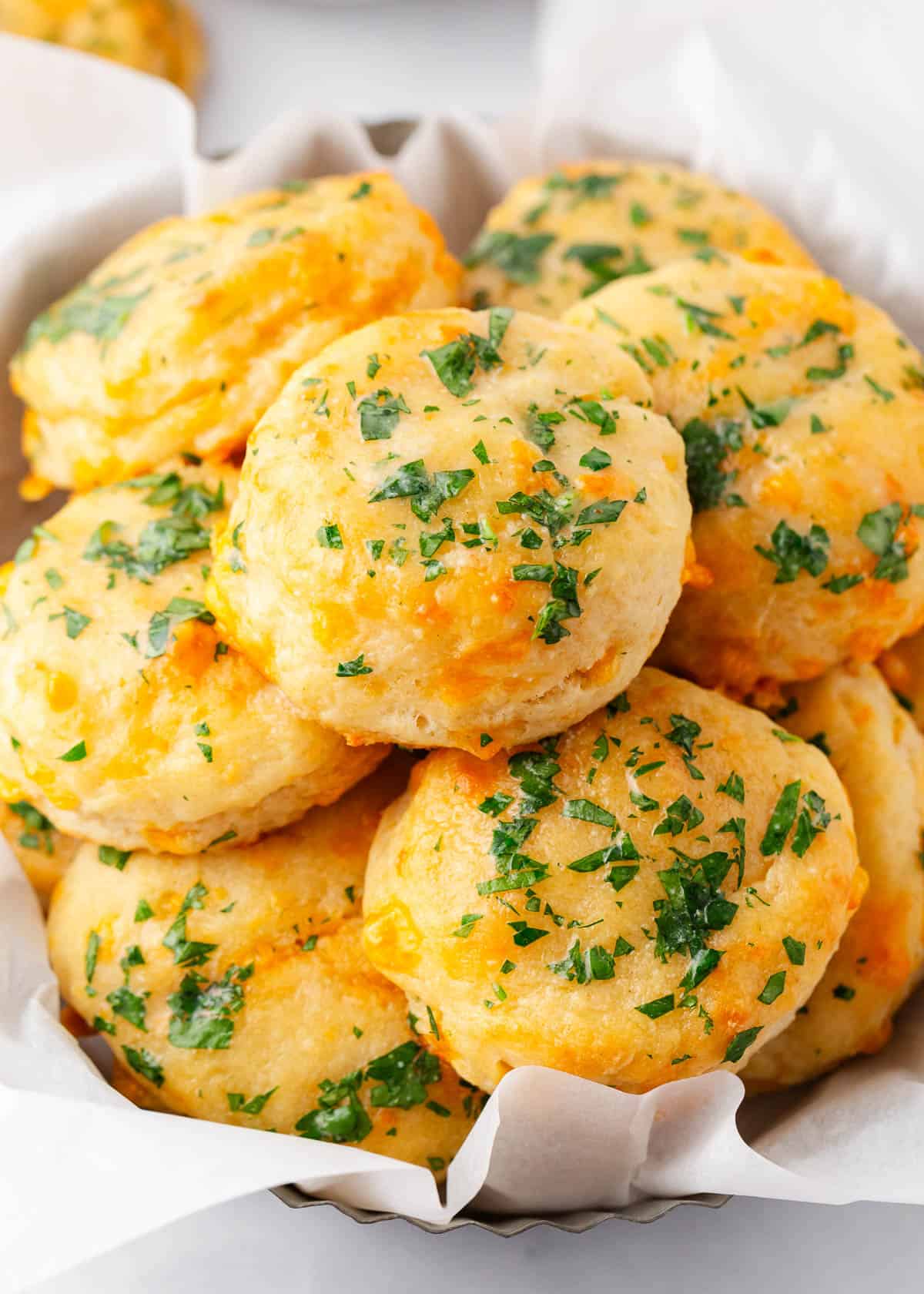 This recipe for copycat Red Lobster cheddar bay biscuits comes together quickly and easily for soft, fluffy, and cheesy biscuits that’ll disappear in minutes! Red Lobster Cheddar Bay Biscuits in a basket.