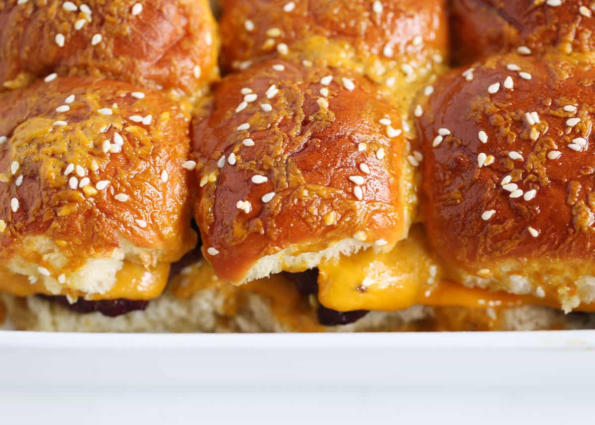 Burger sliders in a white baking dish.