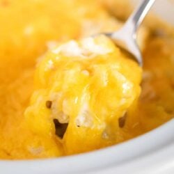 Crockpot cheesy potatoes recipes with melted cheese on top.