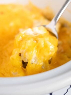 Crockpot cheesy potatoes recipes with melted cheese on top.