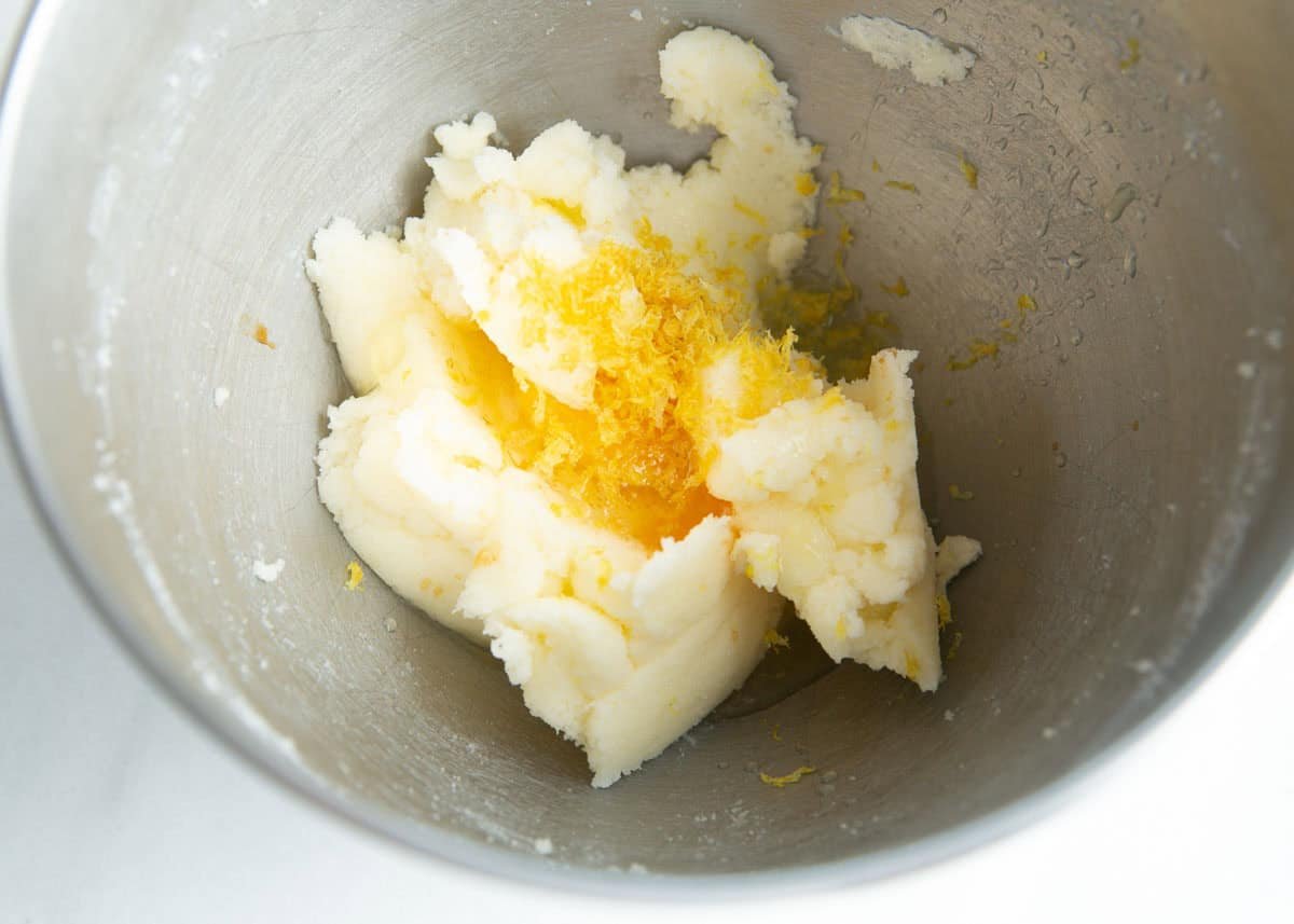 Lemon sugar cookie dough in a mixer bowl.