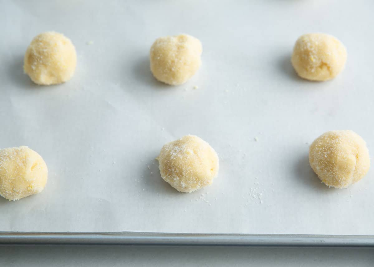 Lemon sugar cookie dough balls on baking sheet.
