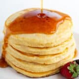 Pouring syrup over my favorite pancake recipe.