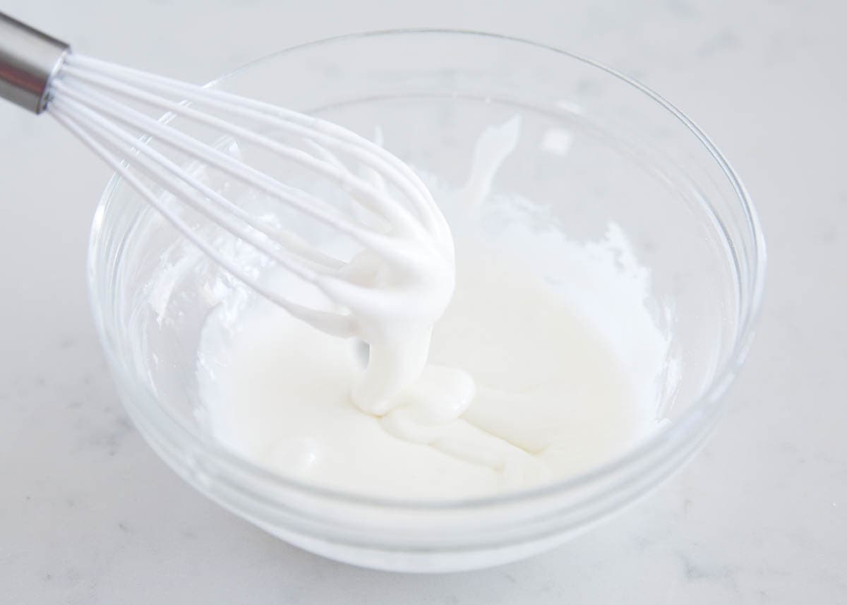 Powdered sugar icing in a glass bowl.