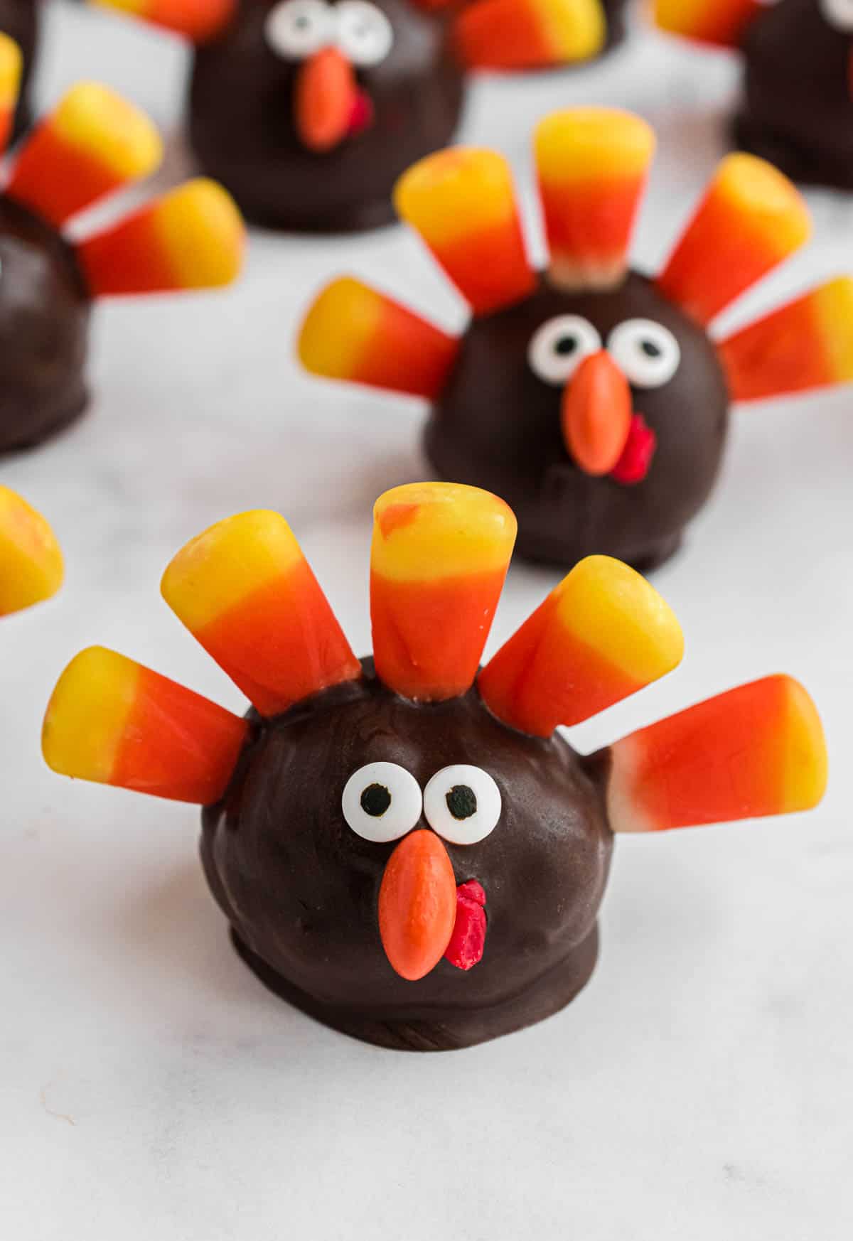 Turkey Oreo balls decorated with candy corn and eyes on the counter.